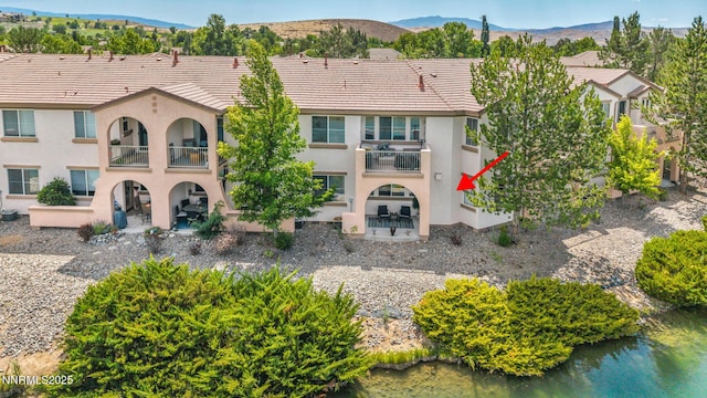 6230 Ingleston Dr Unit 212, Sparks, NV 89436 - rear view of house featuring a balcony, stucco siding, a tiled roof, a patio, and a mountain view