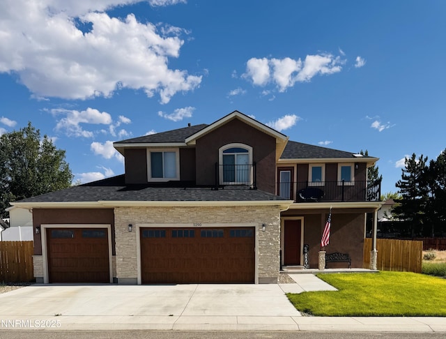 5290 Marla Dr, Winnemucca, NV 89445 - townhome / multi-family property with a balcony, stucco siding, driveway, and an attached garage