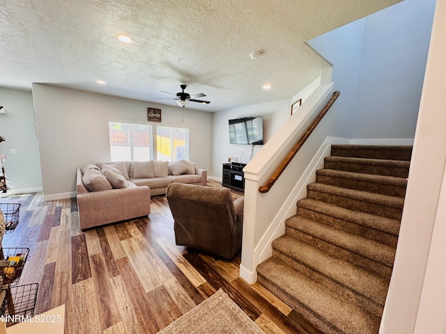 5290 Marla Dr, Winnemucca, NV 89445 - living area featuring a textured ceiling, a ceiling fan, stairway, wood finished floors, and recessed lighting