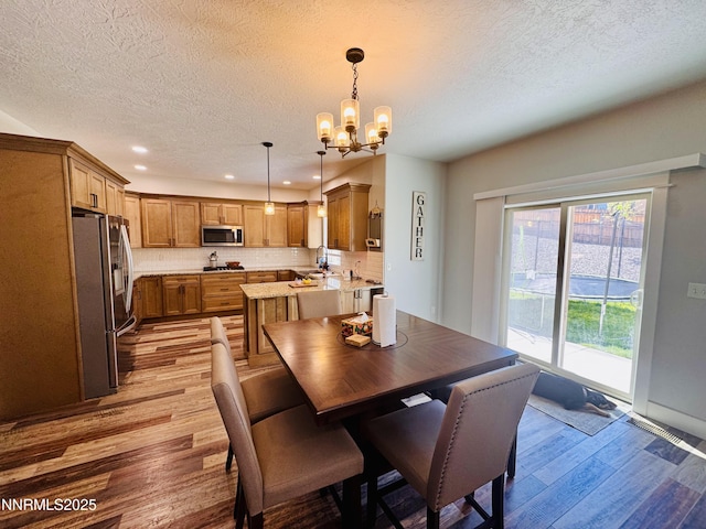 5290 Marla Dr, Winnemucca, NV 89445 - dining room with light wood-style flooring, a textured ceiling, a chandelier, and recessed lighting