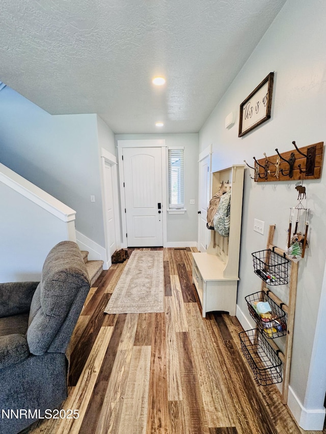 5290 Marla Dr, Winnemucca, NV 89445 - entrance foyer featuring stairs, wood finished floors, and a textured ceiling