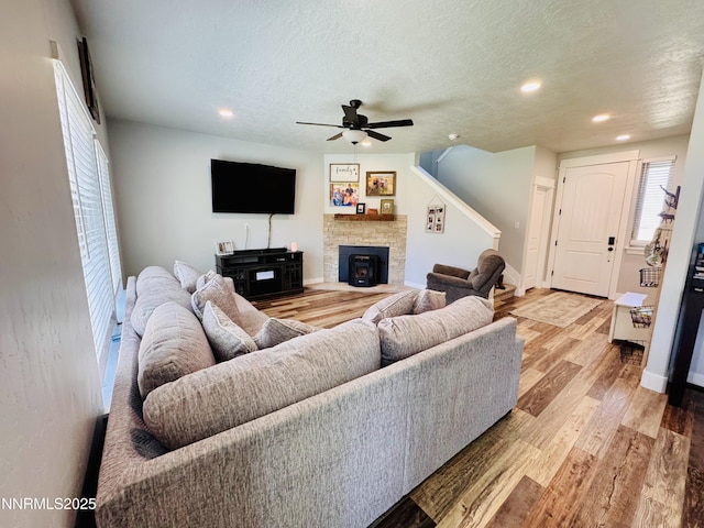 5290 Marla Dr, Winnemucca, NV 89445 - living area featuring ceiling fan, light wood-style flooring, recessed lighting, a textured ceiling, and a fireplace