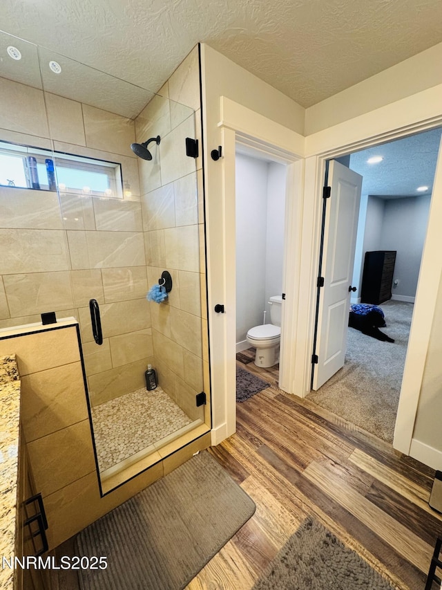 5290 Marla Dr, Winnemucca, NV 89445 - full bath with a shower stall, wood finished floors, and a textured ceiling