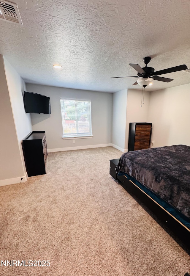 5290 Marla Dr, Winnemucca, NV 89445 - carpeted bedroom with a textured ceiling and ceiling fan