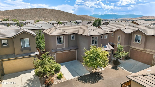 6775 Russian Thistle Dr, Sparks, NV 89436 - view of front of property featuring stucco siding, an attached garage, driveway, and a residential view