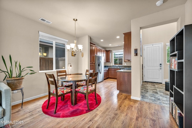 6775 Russian Thistle Dr, Sparks, NV 89436 - dining space featuring a chandelier, light wood-style floors, and recessed lighting