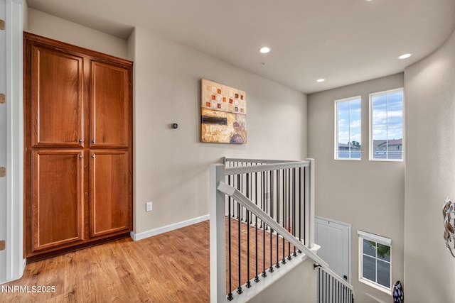 6775 Russian Thistle Dr, Sparks, NV 89436 - hall with an upstairs landing, light wood-style floors, and recessed lighting
