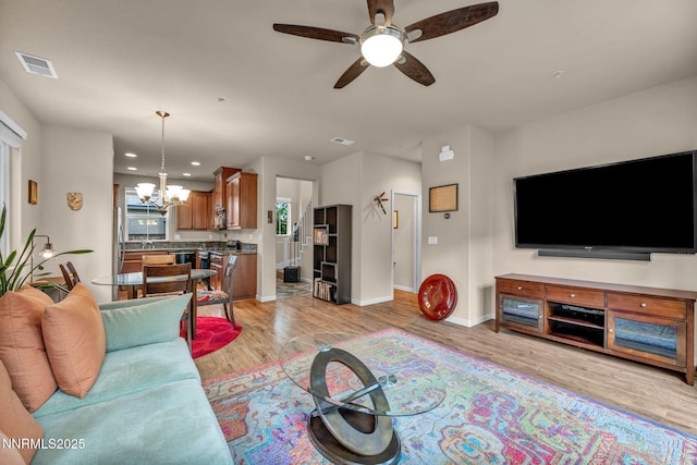 6775 Russian Thistle Dr, Sparks, NV 89436 - living area featuring a chandelier, a ceiling fan, light wood-style floors, and recessed lighting