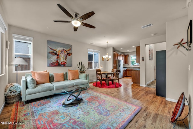 6775 Russian Thistle Dr, Sparks, NV 89436 - living room with light wood-type flooring, ceiling fan, a chandelier, and recessed lighting