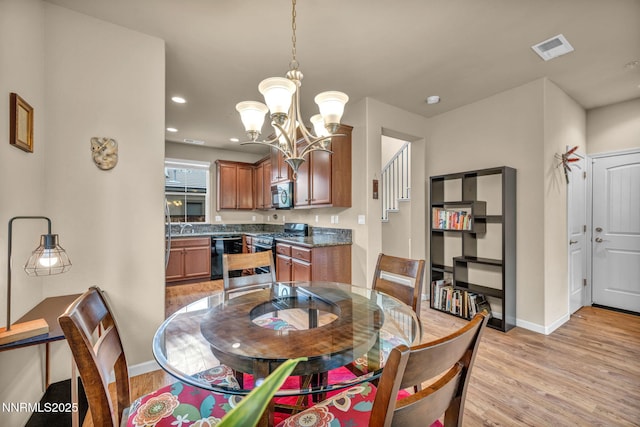 6775 Russian Thistle Dr, Sparks, NV 89436 - dining room with a chandelier, light wood-style flooring, and recessed lighting
