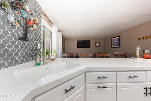 4130 Snowshoe Ln, Reno, NV 89502 - kitchen featuring open floor plan, white cabinets, and light stone countertops