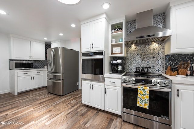 4130 Snowshoe Ln, Reno, NV 89502 - kitchen with stainless steel appliances, wall chimney exhaust hood, light countertops, white cabinets, and tasteful backsplash