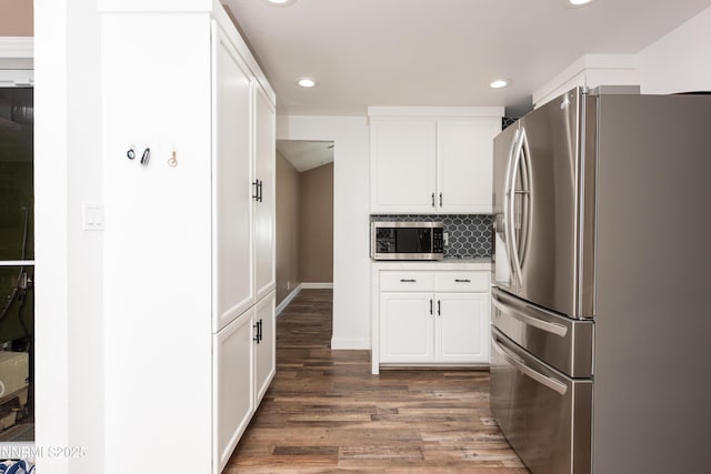 4130 Snowshoe Ln, Reno, NV 89502 - kitchen with stainless steel appliances, white cabinets, wood finished floors, and recessed lighting