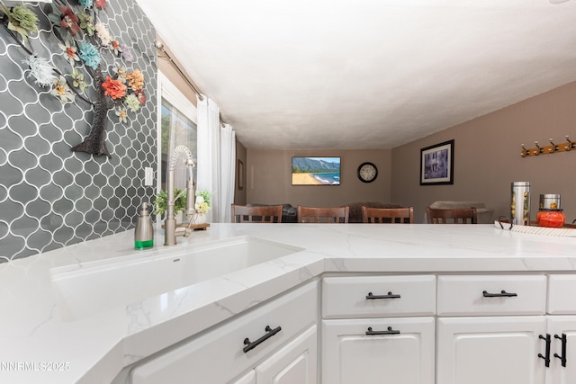 4130 Snowshoe Ln, Reno, NV 89502 - kitchen featuring white cabinetry, plenty of natural light, and light stone countertops