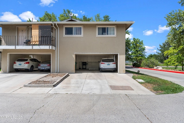 940 Jamaica Ave Unit 3, Reno, NV 89502 - view of front of house featuring an attached garage, stucco siding, and driveway