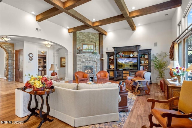 1555 Boulder Field Way, Reno, NV 89511 - living area featuring arched walkways, beam ceiling, wood finished floors, a fireplace, and coffered ceiling