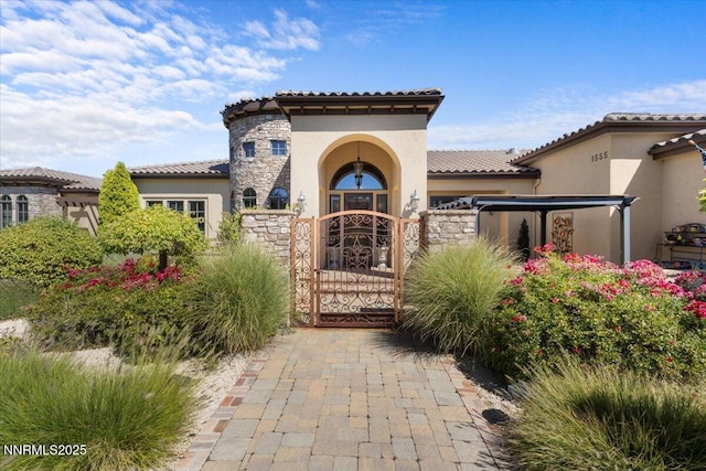 1555 Boulder Field Way, Reno, NV 89511 - entrance to property with stone siding, stucco siding, a gate, and a tiled roof