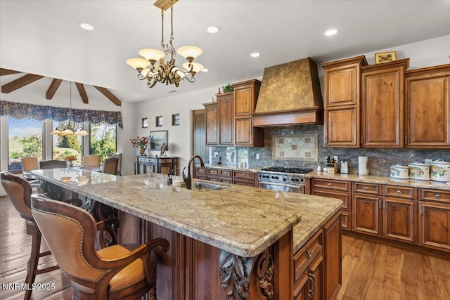 1555 Boulder Field Way, Reno, NV 89511 - kitchen featuring premium range hood, high end range, light stone countertops, a chandelier, and recessed lighting
