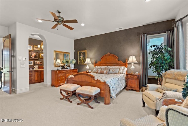 1555 Boulder Field Way, Reno, NV 89511 - bedroom with light carpet, arched walkways, recessed lighting, and a ceiling fan