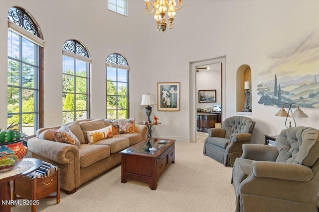 1555 Boulder Field Way, Reno, NV 89511 - living room featuring light colored carpet, a chandelier, healthy amount of natural light, and a high ceiling