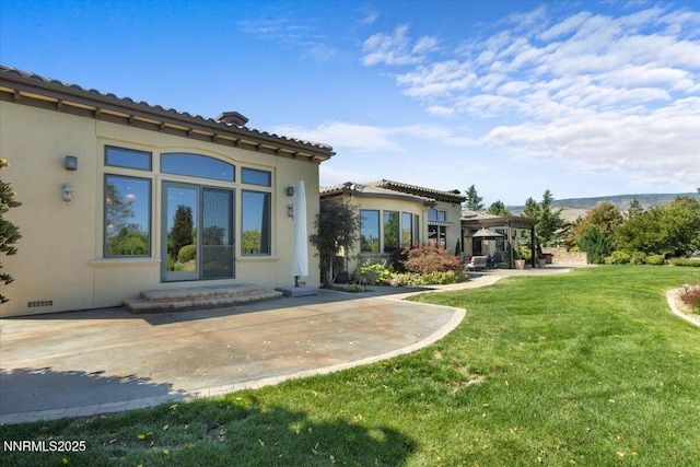 1555 Boulder Field Way, Reno, NV 89511 - rear view of property with a lawn, stucco siding, and a patio area