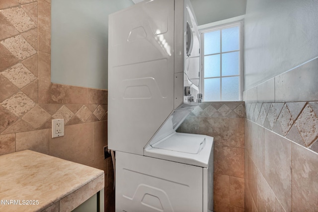 1320 Yori Ave, Reno, NV 89502 - laundry room featuring stacked washing machine and dryer and tile walls