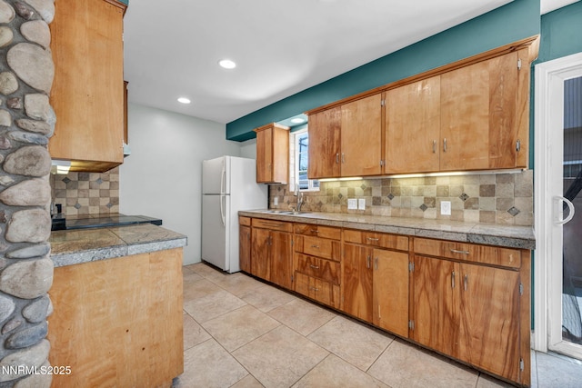 1320 Yori Ave, Reno, NV 89502 - kitchen with freestanding refrigerator, tasteful backsplash, tile countertops, recessed lighting, and brown cabinetry