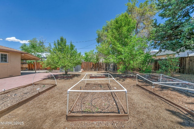 1320 Yori Ave, Reno, NV 89502 - fenced backyard featuring a vegetable garden and an outdoor structure