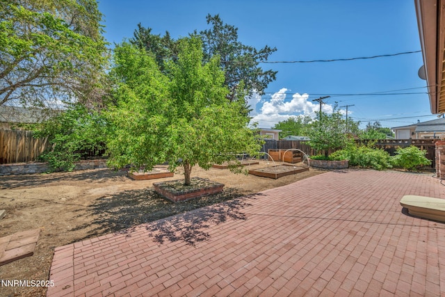 1320 Yori Ave, Reno, NV 89502 - fenced backyard with a vegetable garden and a patio area