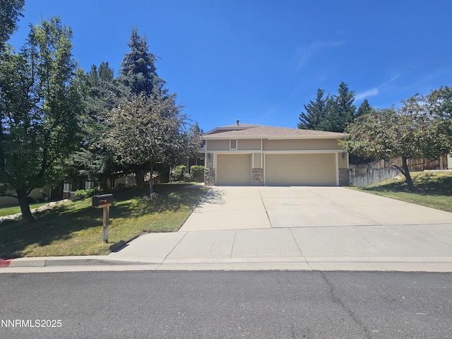 2735 Avenida De Landa, Reno, NV 89523 - view of property hidden behind natural elements with stone siding, driveway, and an attached garage