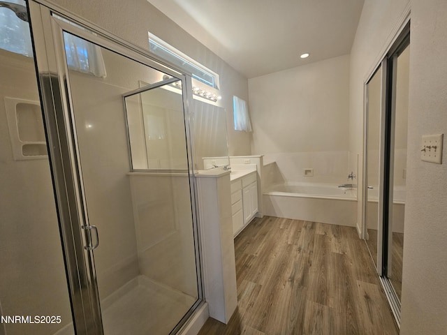2735 Avenida De Landa, Reno, NV 89523 - bathroom with vanity, wood finished floors, a bath, a stall shower, and recessed lighting