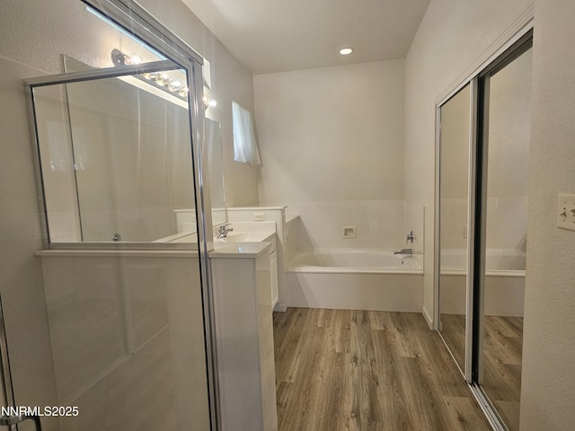 2735 Avenida De Landa, Reno, NV 89523 - bathroom with wood finished floors, vanity, a garden tub, a shower stall, and recessed lighting