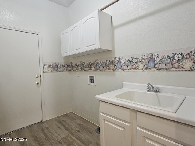 2735 Avenida De Landa, Reno, NV 89523 - laundry area with washer hookup, wood finished floors, and cabinet space
