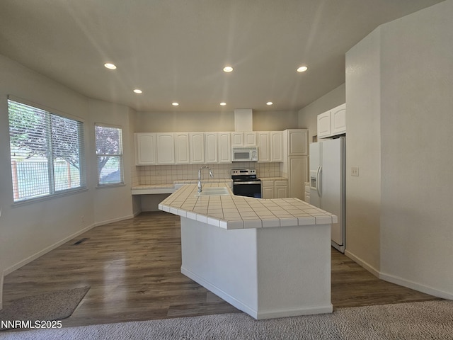 2735 Avenida De Landa, Reno, NV 89523 - kitchen featuring white appliances, tile countertops, recessed lighting, tasteful backsplash, and white cabinets