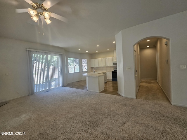 2735 Avenida De Landa, Reno, NV 89523 - unfurnished living room featuring light carpet, arched walkways, a ceiling fan, and recessed lighting