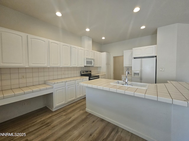 2735 Avenida De Landa, Reno, NV 89523 - kitchen with white appliances, backsplash, dark wood-type flooring, white cabinets, and recessed lighting