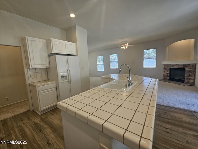 2735 Avenida De Landa, Reno, NV 89523 - kitchen featuring tile counters, white refrigerator with ice dispenser, open floor plan, white cabinetry, and dark wood-style floors