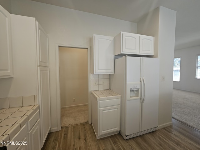2735 Avenida De Landa, Reno, NV 89523 - kitchen featuring white refrigerator with ice dispenser, tile countertops, white cabinets, dark wood-type flooring, and tasteful backsplash