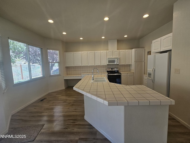 2735 Avenida De Landa, Reno, NV 89523 - kitchen featuring white appliances, tile countertops, recessed lighting, backsplash, and white cabinetry