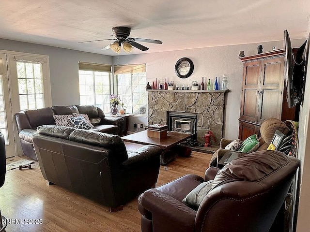 6673 Enchanted Valley Dr, Reno, NV 89523 - living area with light wood-style flooring, a ceiling fan, and a stone fireplace