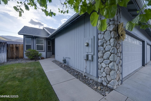 3082 Doubletree Ln, Carson City, NV 89701 - view of side of home featuring an attached garage and roof with shingles