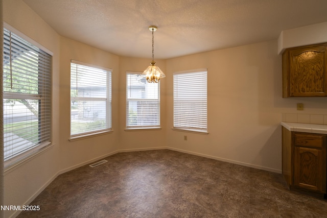 3082 Doubletree Ln, Carson City, NV 89701 - unfurnished dining area featuring a chandelier and a textured ceiling