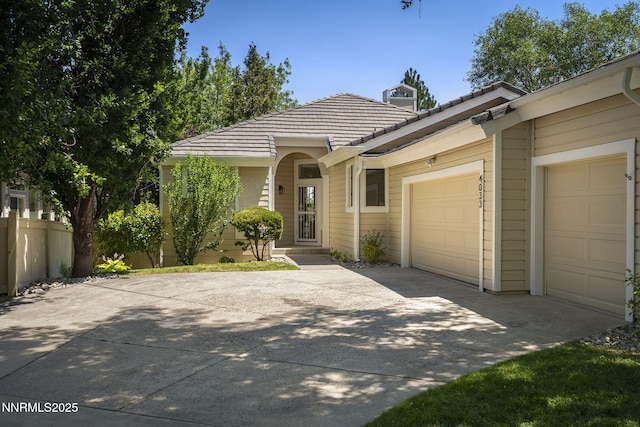 4033 Clover Creek Ct, Reno, NV 89519 - ranch-style house with concrete driveway, an attached garage, and a tiled roof