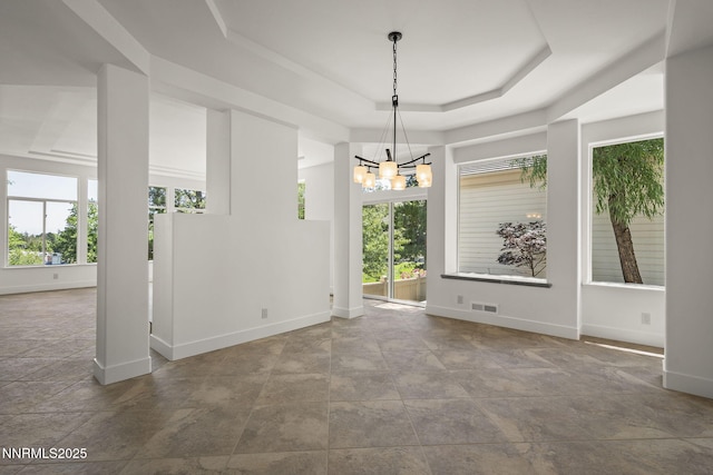 4033 Clover Creek Ct, Reno, NV 89519 - spare room with a chandelier, a raised ceiling, and stone finish flooring