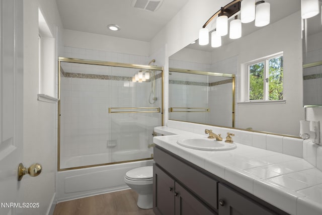4033 Clover Creek Ct, Reno, NV 89519 - bathroom with vanity, bath / shower combo with glass door, and wood finished floors