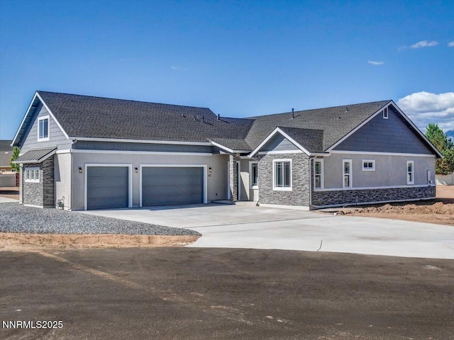 2800 Pamela Pl, Minden, NV 89423 - view of front of home featuring stone siding, concrete driveway, an attached garage, and stucco siding