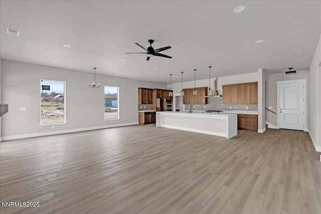 2800 Pamela Pl, Minden, NV 89423 - unfurnished living room featuring a ceiling fan, light wood-style flooring, recessed lighting, and a chandelier