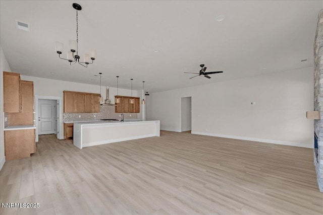 2800 Pamela Pl, Minden, NV 89423 - kitchen with brown cabinets, open floor plan, light countertops, ceiling fan, and a chandelier
