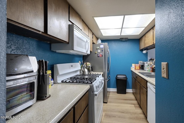 1536 Irene Way, Sparks, NV 89431 - kitchen featuring white appliances, light wood-type flooring, and light countertops