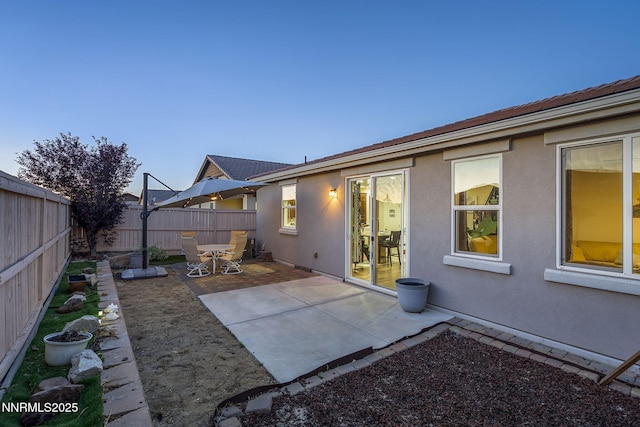 10125 Mesa Cortona Dr, Reno, NV 89521 - back of house with a fenced backyard, stucco siding, and a patio